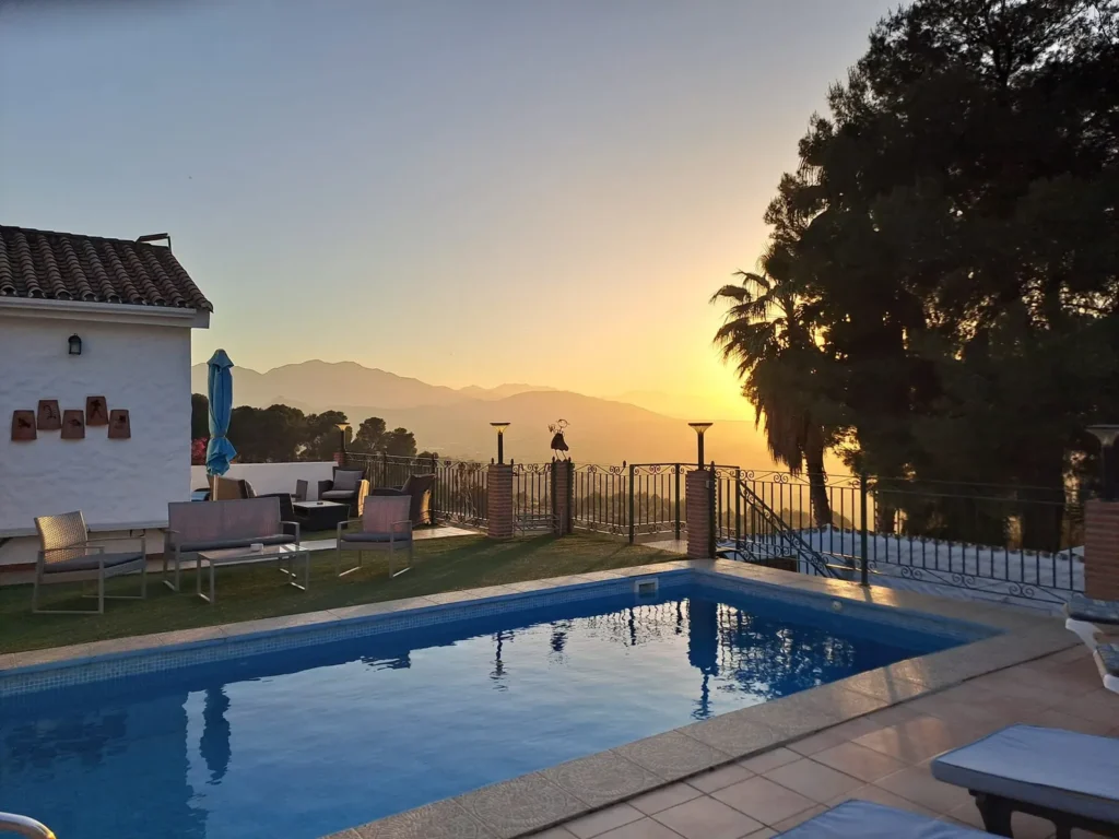 The pool glowing at sunset with the valley beyond